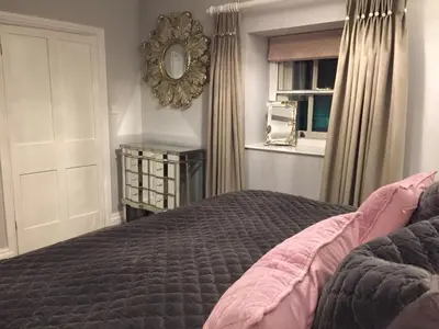 a bedroom with a bed and a mirror on the wall at The Town House BnB in Brecon