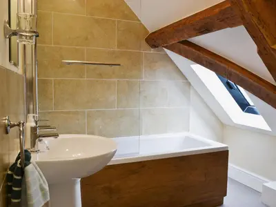a bathroom with a sink and a bath tub at Llaethdy-Milkhouse in Talgarth