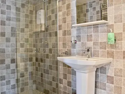 a bathroom with a sink and a shower at Pendref in Trawsfynydd