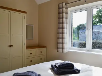 a bedroom with a bed and a window at Roath in Cilcennin
