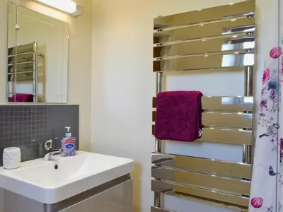 a bathroom with a sink and a mirror at Tawelfan in Cilcennin