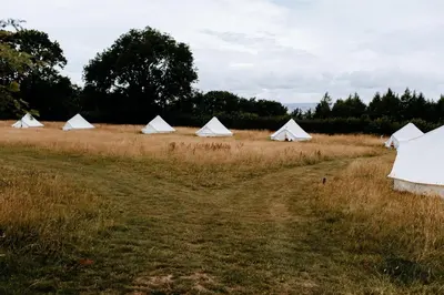 a group of white tents in a field at Drovers Rest Farm Stay in Hay-on-Wye
