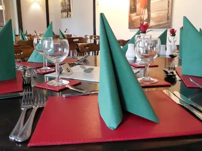 a table with red and green napkins on a table at The Railway Inn in Forden