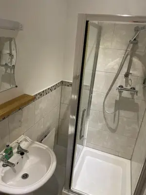 a bathroom with a sink and a shower at Bodalwyn Guest House in Aberystwyth
