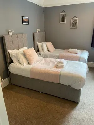 two beds sitting next to each other in a room at Bodalwyn Guest House in Aberystwyth