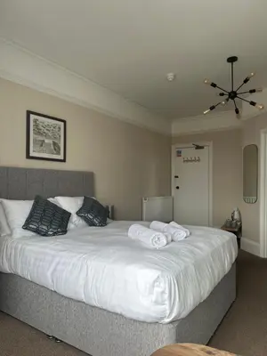 a bedroom with a large white bed with two pillows at Bodalwyn Guest House in Aberystwyth