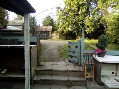 a garden entrance with a blue fence and a chair at Llanerch Inn in Llandrindod Wells