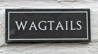 a sign that says watches hanging on a wall at Dee Valley Cottages in Llangollen