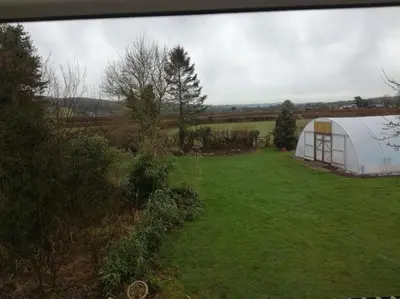 a large white tent in a field of grass at Ty Newydd in Llangadog