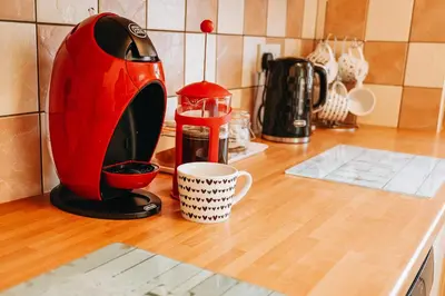 a kitchen counter with a toaster and a coffee cup at Sunnyside farmstay & hottub near Brecon Beacons sleeps 8 in Lower Chapel