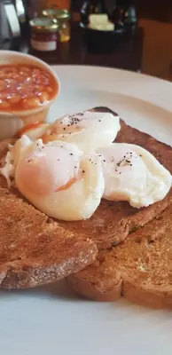 two fried eggs on top of toast on a plate at Plas Yn Dre in Bala