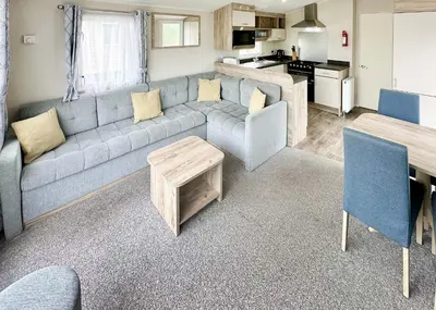 a living room with a couch and a table at Pencnwc Holiday Park in Llanllwchaiarn