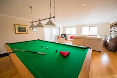 a living room with a pool table at Y Grange in Llanfihangel-y-creuddyn