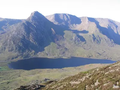 a view of a mountain with a lake in the foreground at Taldraeth - Old Vicarage Guest House in Penrhyndeudreath