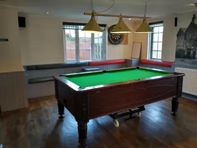 a room with a pool table in the middle at Llanina Arms in Llanarth