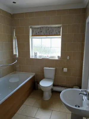 a bathroom with a toilet and a tub and a sink at Llanina Arms in Llanarth