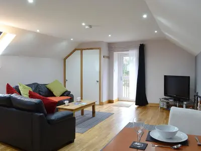 a living room with a couch and a table at The Loft - Uk6210 in Llanerch-Aeron