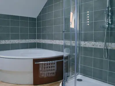 a bathroom with a tub and a glass shower at The Loft - Uk6210 in Llanerch-Aeron