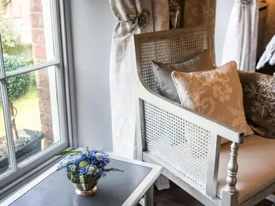 a vase of flowers sitting on a table next to a window at Beautifully decorated, elegant apartment near town - Pass the Keys in Shrewsbury