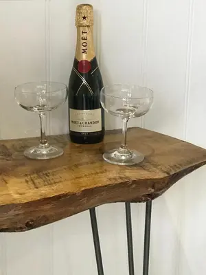 a bottle of wine and two glasses on a table at The Pod & Cwtch luxury accommodation in Aberaeron