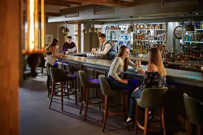 a group of people sitting at a bar at Lion Quays Resort in Oswestry
