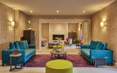 a living room with blue couches and a table at Lion Quays Resort in Oswestry