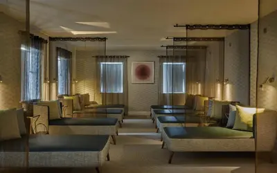a waiting room with couches and tables and windows at Lion Quays Resort in Oswestry
