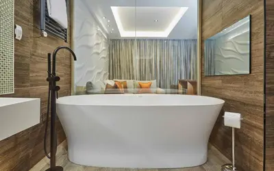 a bath tub in a bathroom with a couch at Lion Quays Resort in Oswestry