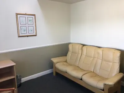 a couch in a room with a picture on the wall at Moreton Park Hotel in Chirk