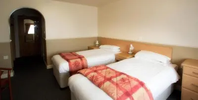 a hotel room with two beds in a room at Moreton Park Hotel in Chirk