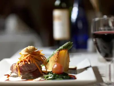 a plate of food on a table with a glass of wine at Metropole Hotel and Spa in Llandrindod Wells