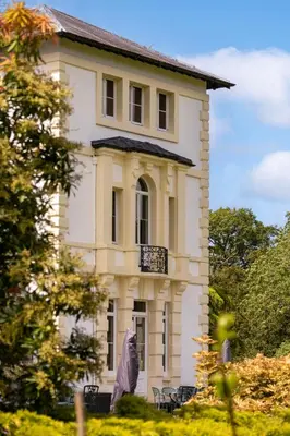 a large white building with a balcony on it at The Falcondale Country House Hotel in Lampeter