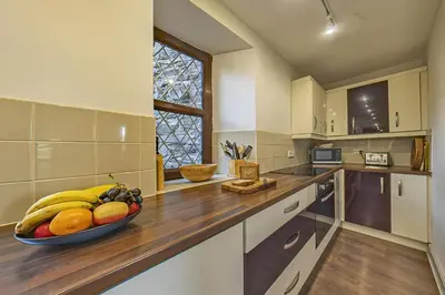 a kitchen with a bowl of fruit on a counter at Gwynfryn in Cerrig-y-Druidion