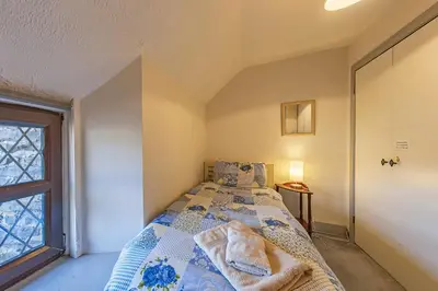 a bedroom with a bed and a window at Gwynfryn in Cerrig-y-Druidion