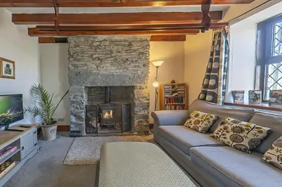 a living room with a couch and a fireplace at Gwynfryn in Cerrig-y-Druidion