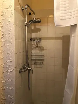 a shower with a shower head in a bathroom at Leamington House in Barmouth