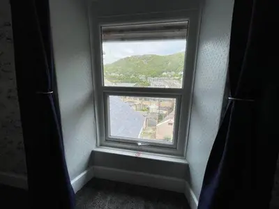 a window in a room with a view of a city at Seascape in Barmouth
