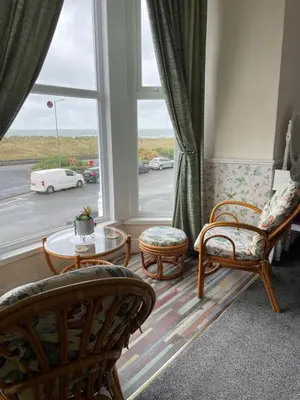 a living room with chairs and a large window at Seascape in Barmouth