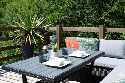 a black table with plates and napkins on a patio at Cegir Escapes in Darowen