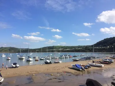 a bunch of boats are docked in the water at The Bakery in Llanddeiniol