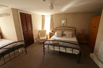 a bedroom with two bunk beds and a chair at Fitzwarine House Whittington in Whittington