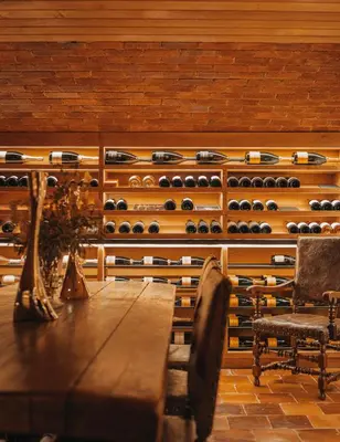 a room with a table and a bunch of wine bottles at Palé Hall in Bala
