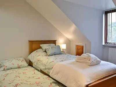 a bedroom with two beds and a window at Dyffryn Haidd in Llanafan