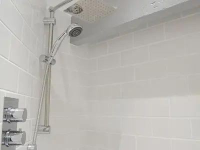 a shower with a shower head in a bathroom at Seascape in New Quay
