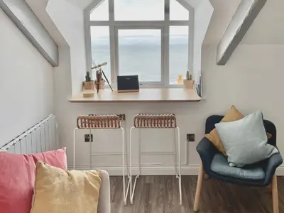 a room with a table and two chairs and a window at Seascape in New Quay
