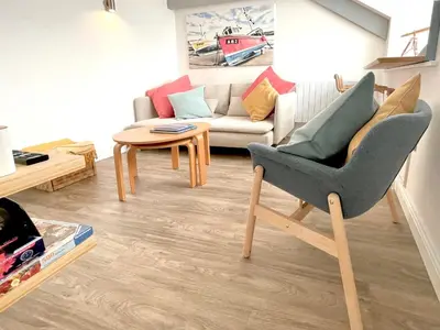 a living room with a couch and a chair at Seascape in New Quay
