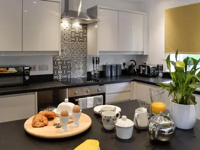 a kitchen with a table with eggs and croissants on it at Bryn Aled in Llanfachreth