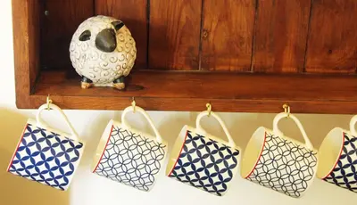 a bunch of bags hanging on a shelf with a vase at Drovers Retreat in Llandrindod Wells