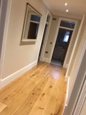 an empty hallway with a wooden floor in a house at Llys y Barnwr - Judge's Court in Aberystwyth