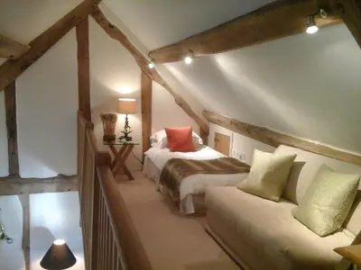 a bedroom with a bed and a couch at The Barn at Titley in Kington